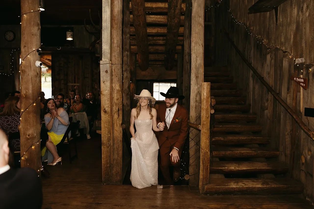 Bride and groom entering rustic venue